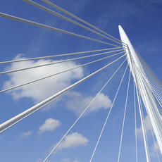 Suspension bridge with a bright blue sky in the background