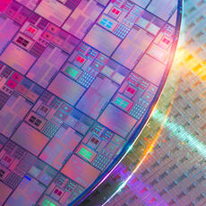 Image of silicon wafers and microcircuits reflecting a holographic array of colors