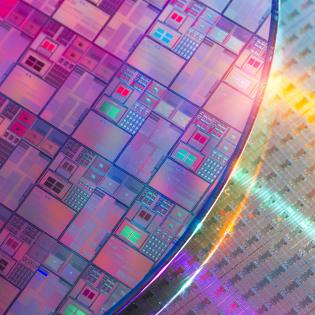 Image of silicon wafers and microcircuits reflecting a holographic array of colors